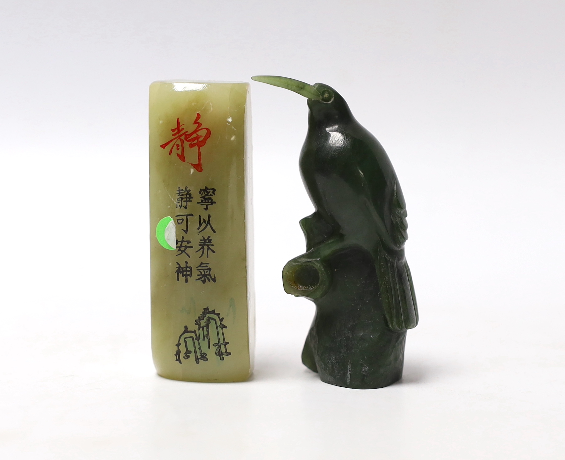 A carved spinach green jade model of a bird and a Chinese soapstone scroll weight, largest 7cm high